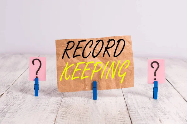 Word writing text Record Keeping. Business concept for The activity or occupation of keeping records or accounts Scribbled and crumbling sheet with paper clips placed on the wooden table. — Stock Fotó