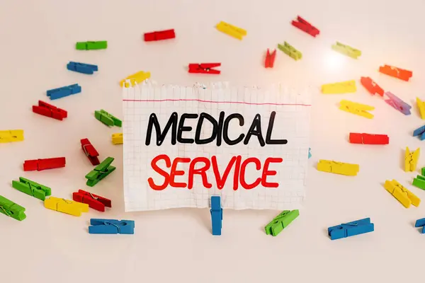 Conceptual hand writing showing Medical Service. Business photo showcasing treat illnesses and injuries that require medical response Colored clothespin papers empty reminder white floor office. — 图库照片