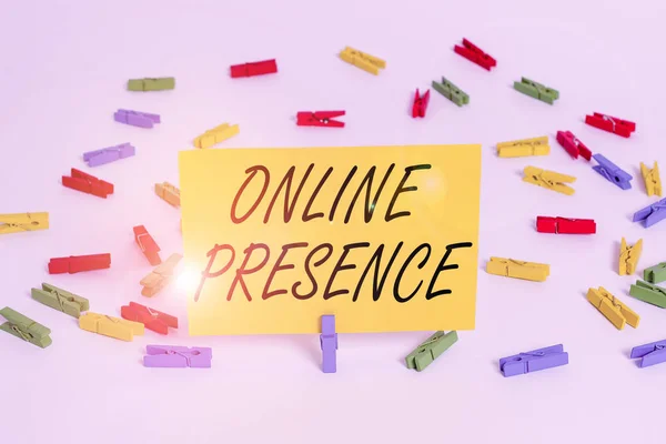 Handwriting text Online Presence. Concept meaning existence of an individual can be found via an online search Colored clothespin papers empty reminder white floor background office.