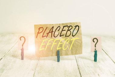 Word writing text Placebo Effect. Business concept for a beneficial effect produced by a placebo drug or treatment Scribbled and crumbling sheet with paper clips placed on the wooden table.