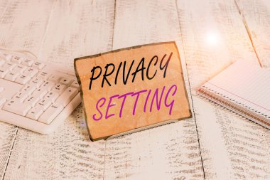 Text sign showing Privacy Setting. Conceptual photo limit the access of profile and what information can see Notepaper stand on buffer wire in between computer keyboard and math sheets.