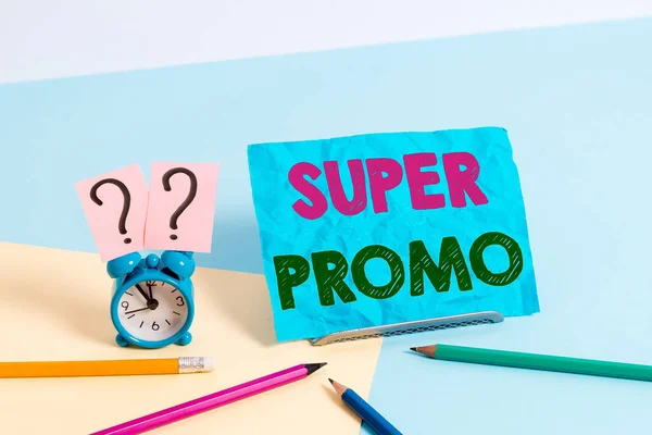 Word writing text Super Promo. Business concept for piece of publicity or advertising in the form of a short film Mini size alarm clock beside stationary placed tilted on pastel backdrop. — Stockfoto