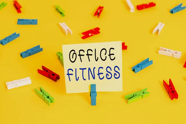 Writing note showing Office Fitness. Business photo showcasing Encouraging fitness and balance lifestyle in the workplace Colored clothespin papers empty reminder yellow floor background office.