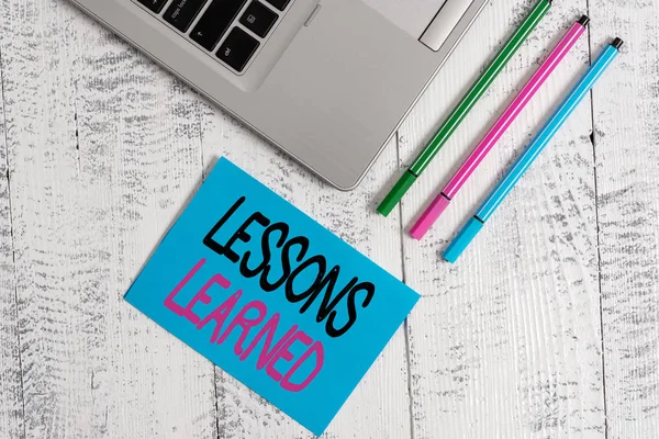 Handwriting text writing Lessons Learned. Concept meaning the knowledge or understanding gained by experience Trendy metallic laptop blank sticky pad three pens lying vintage table. — Φωτογραφία Αρχείου