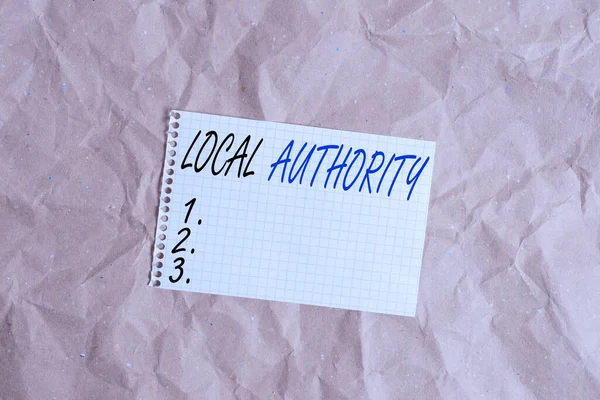 Text sign showing Local Authority. Conceptual photo the group of showing who govern an area especially a city Papercraft craft paper desk square spiral notebook office study supplies. — Stockfoto