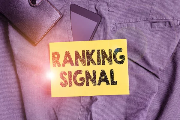 Word writing text Ranking Signal. Business concept for characteristic of a website that search engine algorithms Smartphone device inside trousers front pocket with wallet and note paper. — 图库照片