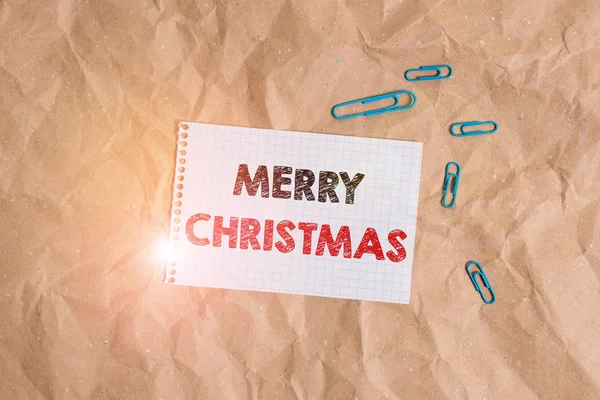 Conceptual hand writing showing Merry Christmas. Business photo showcasing annual tradition to celebrate the birth of Jesus Christ Papercraft desk square spiral notebook office study supplies. — Stockfoto