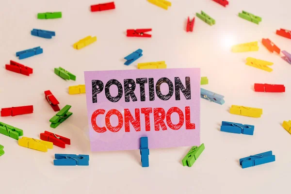 Word writing text Portion Control. Business concept for knowing the correct measures or serving sizes as per calorie Colored clothespin papers empty reminder white floor background office.