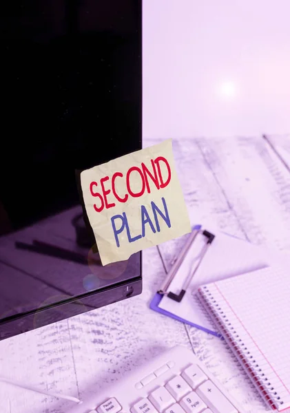 Writing note showing Second Plan. Business photo showcasing next set of decisions about how to do something in the future Note paper taped to black computer screen near keyboard and stationary. — Stockfoto