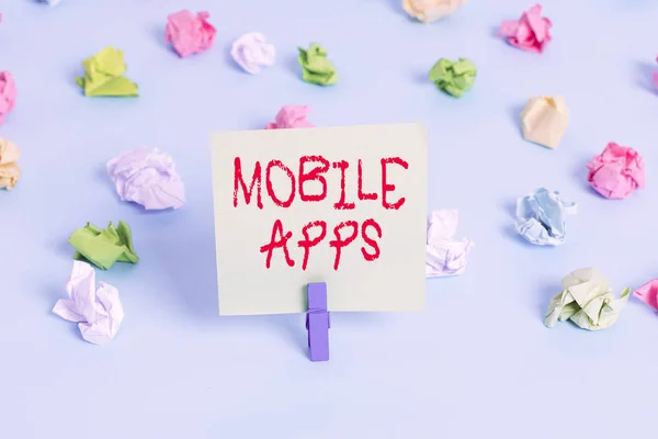 Word σύνταξη κειμένου Mobile Apps. Επιχειρηματική ιδέα για λογισμικό εφαρμογής σχεδιασμένο για να λειτουργεί σε κινητές συσκευές Έγχρωμα τσαλακωμένα χαρτιά κενό υπενθύμιση μπλε φόντο clothespin. — Φωτογραφία Αρχείου