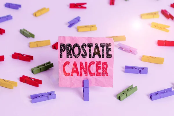 Conceptual hand writing showing Prostate Cancer. Business photo text cancer develops in the gland of male reproductive system Colored clothespin papers empty reminder white floor office.