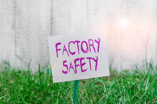 Text sign showing Factory Safety. Conceptual photo minimize risk of worker injury while doing production tasks Plain empty paper attached to a stick and placed in the green grassy land.
