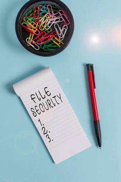 Conceptual hand writing showing File Security. Business photo text Protecting digital data such as those in a database from loss Notebook and stationary with mouse above pastel backdrop.