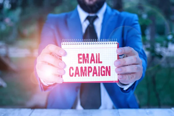 Handwriting text Email Campaign. Concept meaning advertisements are sent to a targeted list of recipients Man holds empty paper with copy space in front of him.