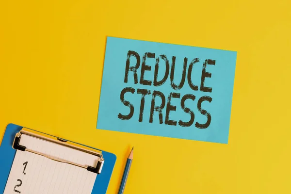 Conceptual hand writing showing Reduce Stress. Business photo text to relieve the tension and engage to quality lifestyle Clipboard holding paper sheet square page pen colored background. — Φωτογραφία Αρχείου