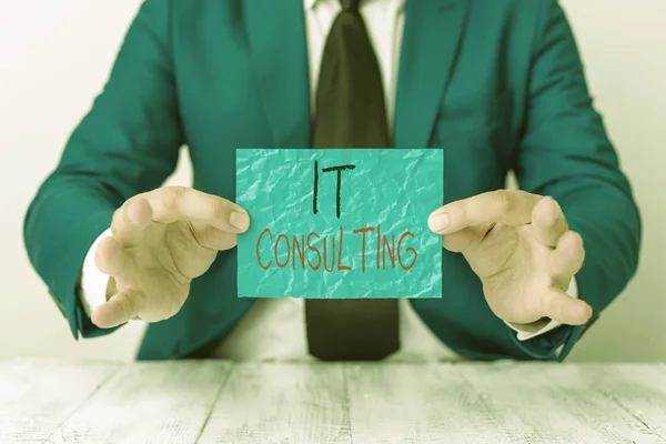 Text sign showing It Consulting. Conceptual photo Focuses on advising organizations hot to manage their IT Man holds empty paper with copy space in front of him Copy Space. — 스톡 사진