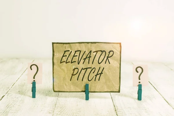 Writing note showing Elevator Pitch. Business photo showcasing the elevator statement is a short description of an idea Crumbling sheet with paper clips placed on the wooden table. — 图库照片