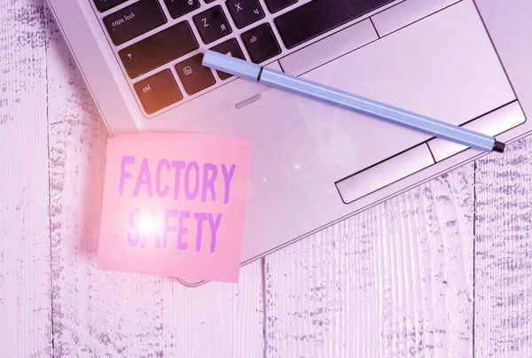 Handwriting text Factory Safety. Concept meaning minimize risk of worker injury while doing production tasks Trendy slim silver metallic laptop blank sticky pad pen lying vintage table.