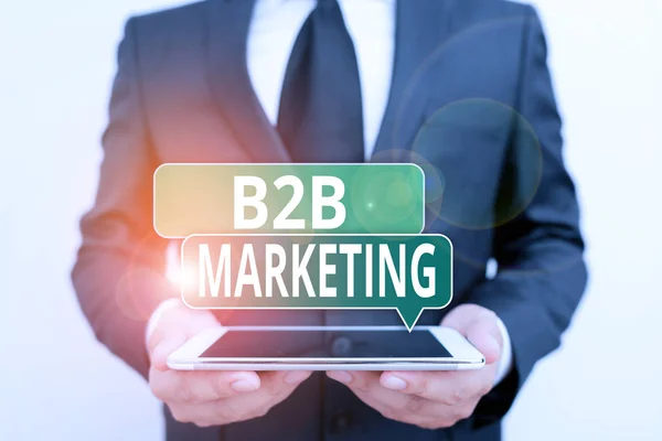 Conceptual hand writing showing B2B Marketing. Business photo showcasing marketing of products to businesses or other organizations Male human wear formal work suit hold hitech smartphone. — Stock Fotó