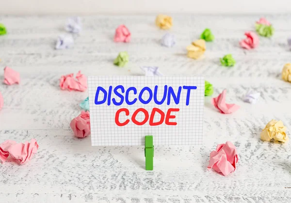 Conceptual hand writing showing Discount Code. Business photo text Series of letters or numbers that allow you to get a discount Green clothespin white wood background reminder office supply. — Stock Photo, Image