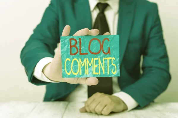 Writing note showing Blog Comments. Business photo showcasing Space at the end of each post for a reader to leave a comment Man holds empty paper with copy space in front of him Space.