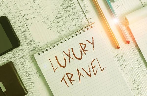 Text sign showing Luxury Travel. Conceptual photo supreme comfort or elegance of traveling around the world Smartphone man wallet notebook pens ballpoints note pad old wooden table. — Stock Fotó