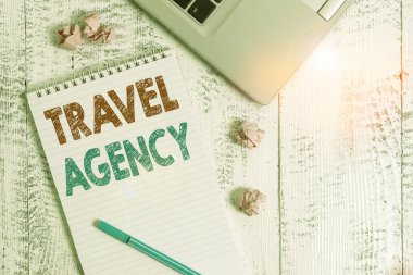 Conceptual hand writing showing Travel Agency. Business photo showcasing Agency that makes the necessary arrangements for travelers Laptop ruled spiral notepad crushed paper balls wooden table. clipart