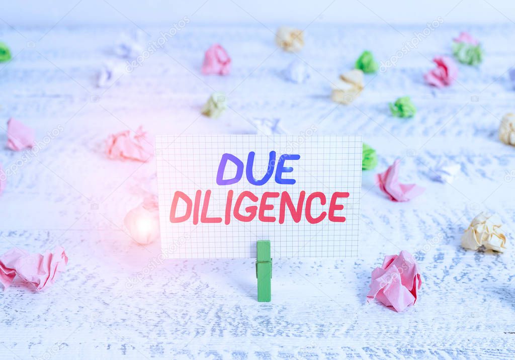 Conceptual hand writing showing Due Diligence. Business photo text Rational steps taken by a demonstrating to avoid committing a tort Green clothespin white wood background reminder office supply.