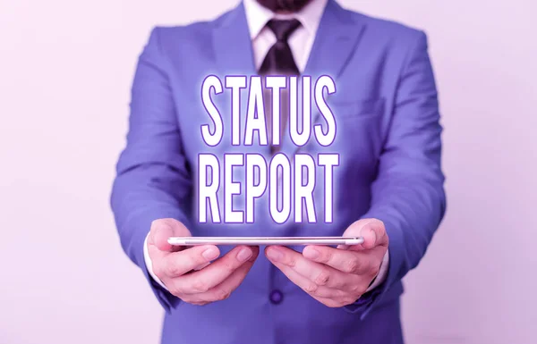Word writing text Status Report. Business concept for document relating a situation of something such as a project Businessman in blue suite with a tie holds lap top in hands.