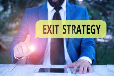 Handwriting text Exit Strategy. Concept meaning Extricating oneself from a situation that is become difficult Businessman with pointing finger in front of him.