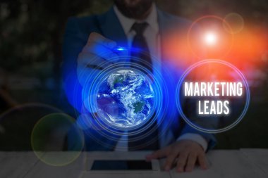 Writing note showing Marketing Leads. Business photo showcasing demonstrating who shows interest in the brand or products Elements of this image furnished by NASA.