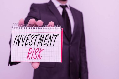 Text sign showing Investment Risk. Conceptual photo potential financial loss inherent in an investment decision Male human wear formal work suit office look hold mathematics book use hand.
