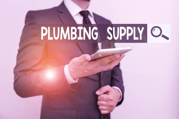 Text sign showing Plumbing Supply. Conceptual photo tubes or pipes connect plumbing fixtures and appliances Male human wear formal work suit hold smart hi tech smartphone use one hand.