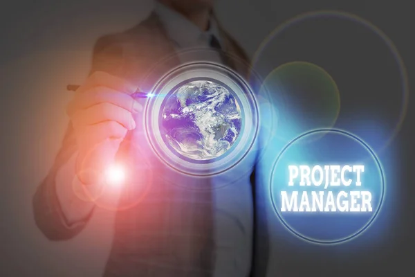 Writing note showing Project Manager. Business photo showcasing overall charge of the planning and execution of a project Elements of this image furnished by NASA. — Stockfoto