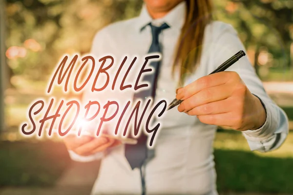 Handwriting text writing Mobile Shopping. Concept meaning trading of goods and services through wireless devices Woman in a blue business shirts pointing with her finger into empty space. — 스톡 사진