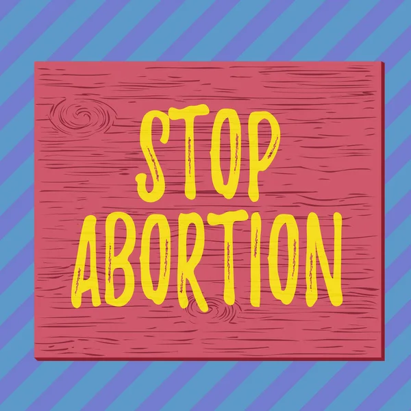 Manuscrito texto escrito Stop Abortion. Conceito que significa parar o procedimento médico que costumava acabar com uma gravidez Quadrado retângulo irreal madeira cartoon pregado preso na parede colorida . — Fotografia de Stock