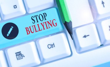 Zorbalığı Durdurun 'u gösteren bir not yazıyorum. İş fotoğrafı gösterimi okul çağındaki çocuklar arasındaki agresif davranışları durdurur.