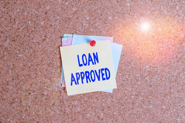 Text sign showing Loan Approved. Conceptual photo sum of money borrowed by a customer to a bank is granted Corkboard color size paper pin thumbtack tack sheet billboard notice board.