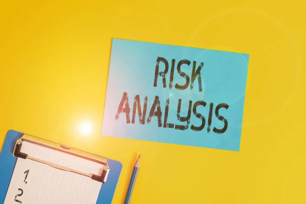 Conceptual hand writing showing Risk Analysis. Business photo text review of the risks associated with a particular event Clipboard holding paper sheet square page pen colored background. — Stockfoto
