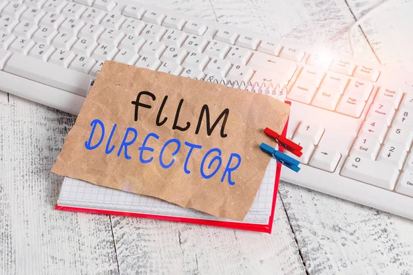 Handwriting text writing Film Director. Concept meaning a demonstrating who is in charge of making and directing a film notebook paper reminder clothespin pinned sheet white keyboard light wooden. — Zdjęcie stockowe