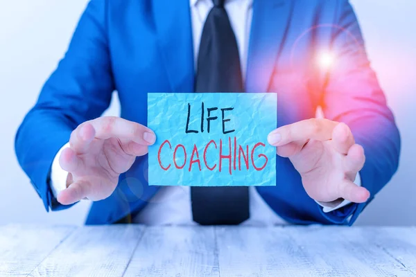 Text sign showing Life Coaching. Conceptual photo a demonstrating employed to help showing attain their goals in life Man holds empty paper with copy space in front of him Copy Space.