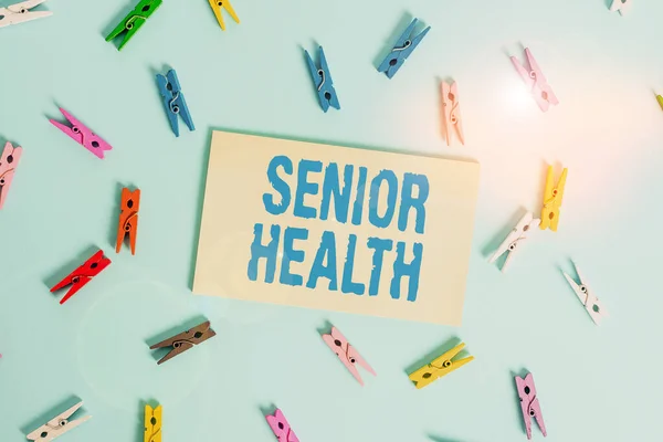 Conceptual hand writing showing Senior Health. Business photo text refers to physical and mental conditions of senior citizens Colored clothespin rectangle shaped paper blue background.