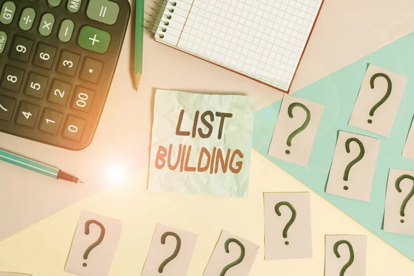Writing note showing List Building. Business photo showcasing database of showing you can contact with your marketing message Mathematics stuff and writing equipment above pastel colours background.