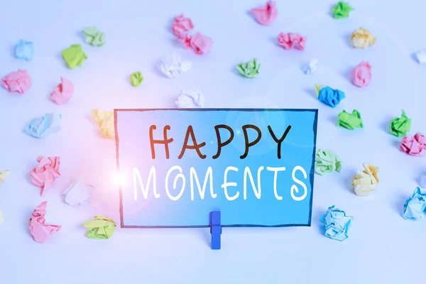 Text sign showing Happy Moments. Conceptual photo Feelings of pleasure or satisfaction with their life Colored crumpled papers empty reminder white floor background clothespin. — Stock Photo, Image