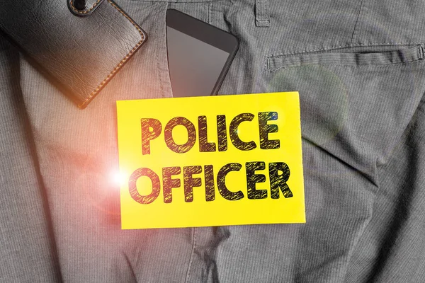 Word writing text Police Officer. Business concept for a demonstrating who is an officer of the law enforcement team Smartphone device inside trousers front pocket with wallet and note paper. — Stock Photo, Image