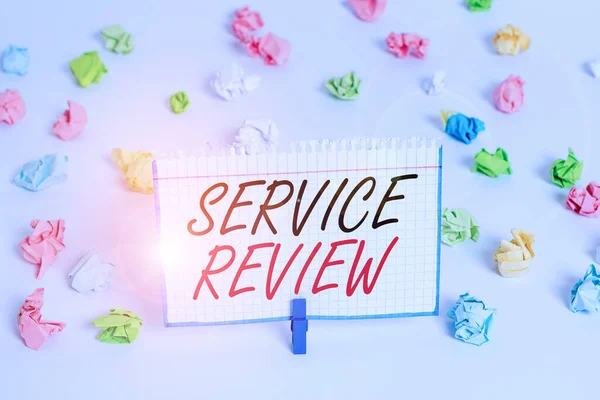 Word writing text Service Review. Business concept for an option for customers to rate a company s is service Colored crumpled papers empty reminder white floor background clothespin.