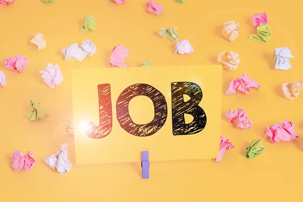 Text sign showing Job. Conceptual photo A paid position of regular employment Occasional work Piece of task Colored crumpled papers empty reminder white floor background clothespin. — ストック写真