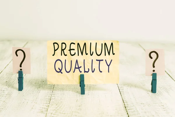 Writing note showing Premium Quality. Business photo showcasing something or someone of greater or superior quality Crumbling sheet with paper clips placed on the wooden table. — Stock Photo, Image