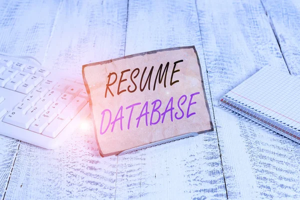 Text sign showing Resume Database. Conceptual photo database of candidates that you can search by skillset Notepaper stand on buffer wire in between computer keyboard and math sheets.