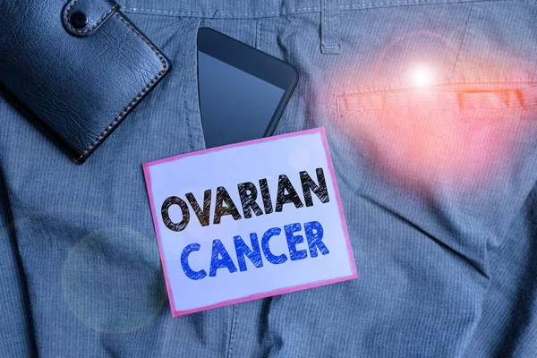 Handwriting text Ovarian Cancer. Concept meaning any cancerous growth that forms in the tissues of the ovary Smartphone device inside trousers front pocket with wallet and note paper.